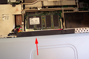 Fixing Powerbook Random Freeze Problem: Figure 2: Plastic strip electrical-taped over apex of bend in trackpad ribbon cable